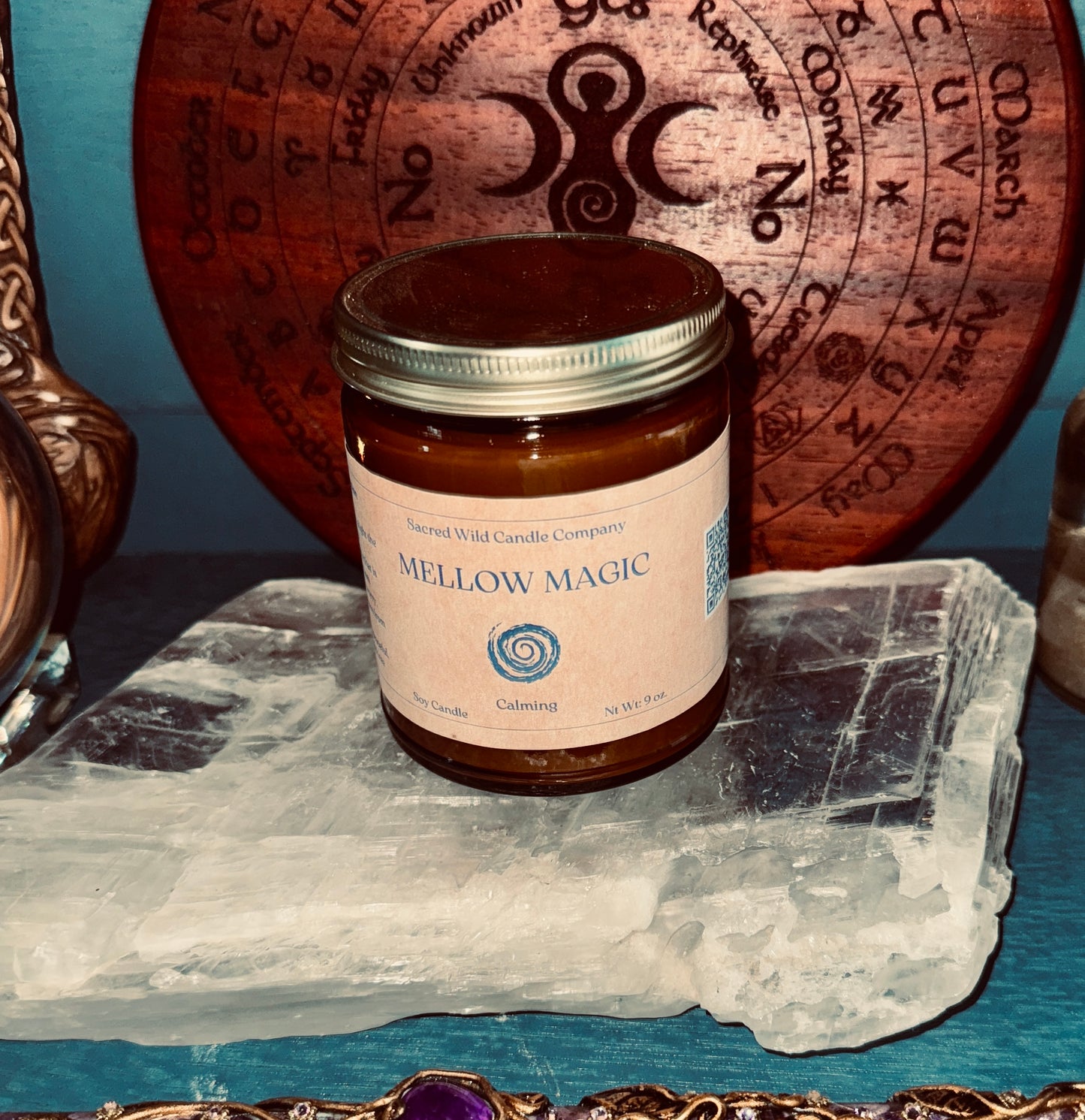 Jar of 'Mellow Magic' candle on a crystal with a decorative background